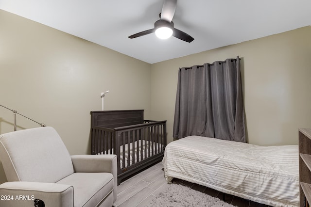 bedroom with light hardwood / wood-style floors and ceiling fan