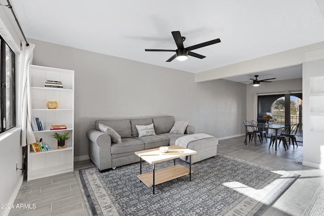 living room featuring ceiling fan and hardwood / wood-style flooring