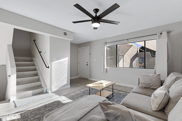 living room with light hardwood / wood-style flooring and ceiling fan