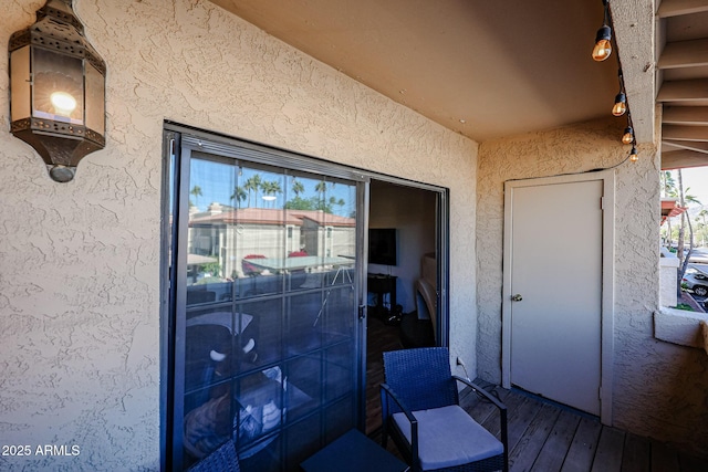 view of exterior entry featuring a balcony