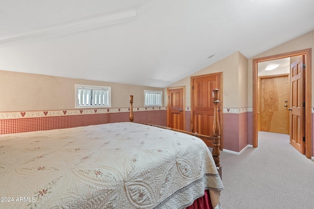 bedroom with vaulted ceiling and carpet