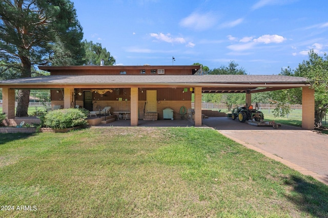 exterior space featuring a carport and a front yard