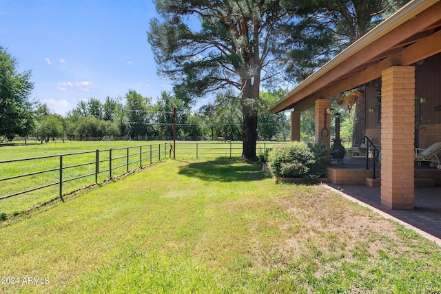 view of yard with a rural view and a patio