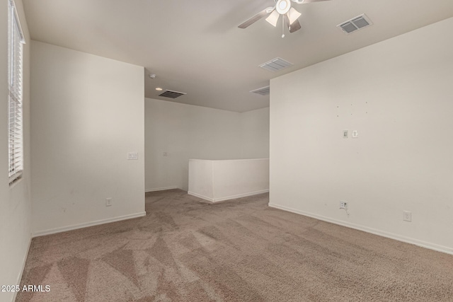 unfurnished room with ceiling fan and light colored carpet