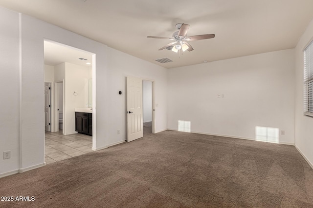 carpeted spare room with ceiling fan