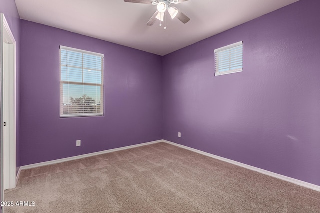 carpeted spare room with ceiling fan