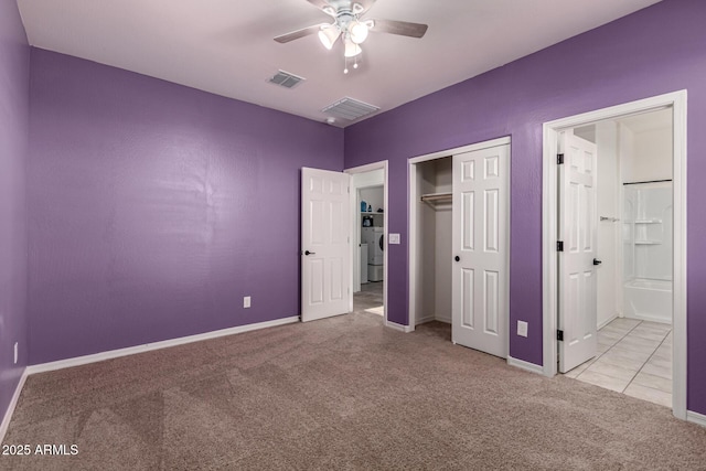 unfurnished bedroom featuring ensuite bath, ceiling fan, a closet, and light colored carpet