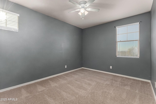 carpeted spare room with ceiling fan