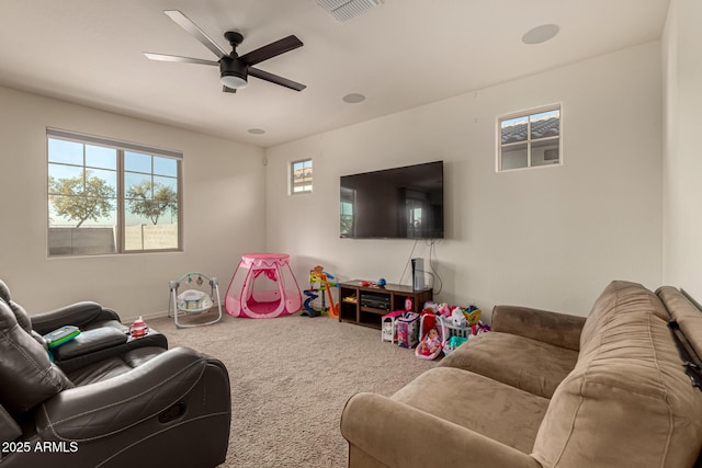 carpeted living room featuring ceiling fan