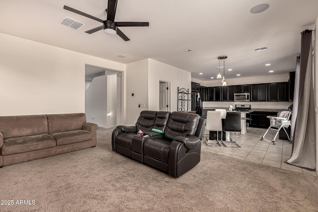 living room with ceiling fan and light tile patterned floors