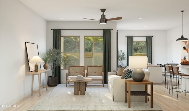 living room featuring ceiling fan, light hardwood / wood-style floors, and a healthy amount of sunlight