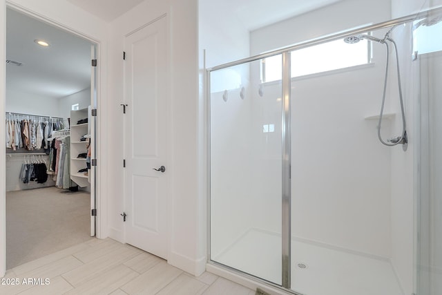 9645 E Ripple Dr, Mesa, AZ 85212 - full bathroom with a stall shower, a spacious closet, and recessed lighting