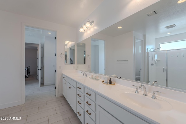 9645 E Ripple Dr, Mesa, AZ 85212 - bathroom with double vanity, a stall shower, and recessed lighting