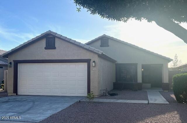 ranch-style house featuring stucco siding, concrete driveway, and a garage