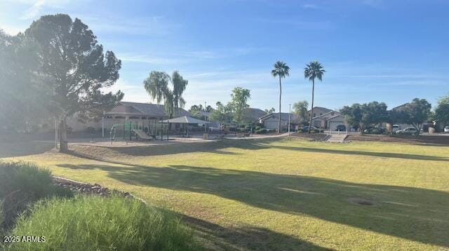 surrounding community featuring playground community and a yard