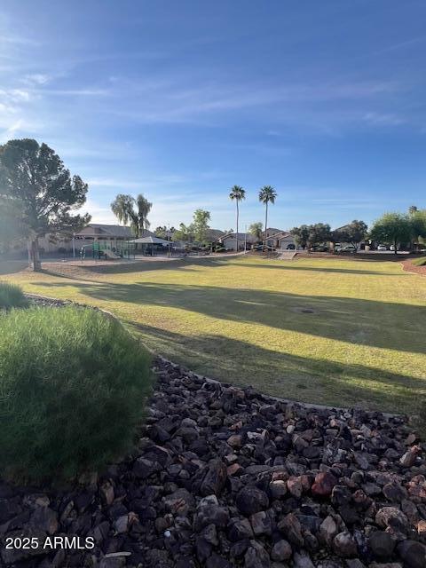 view of property's community featuring a yard