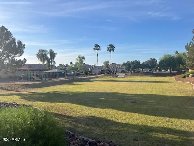 surrounding community featuring a lawn and playground community
