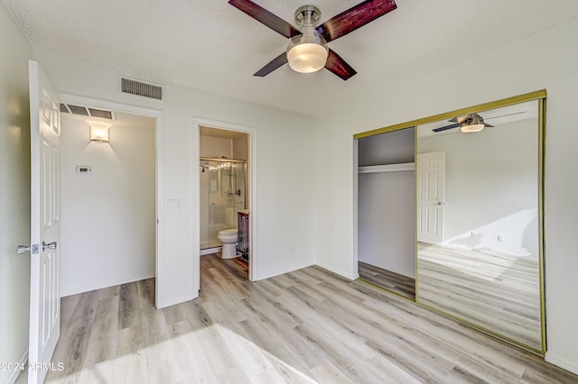 unfurnished bedroom with light hardwood / wood-style floors, ensuite bath, a closet, and ceiling fan