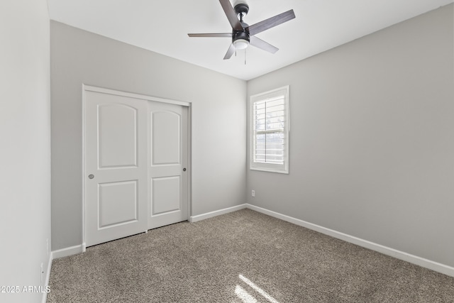 unfurnished bedroom with ceiling fan, a closet, and carpet flooring