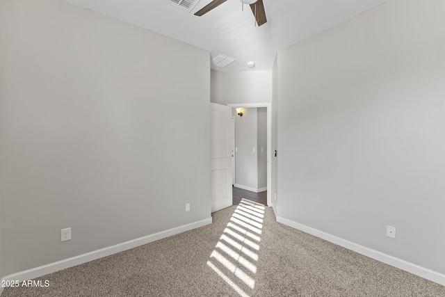 empty room with ceiling fan and carpet floors