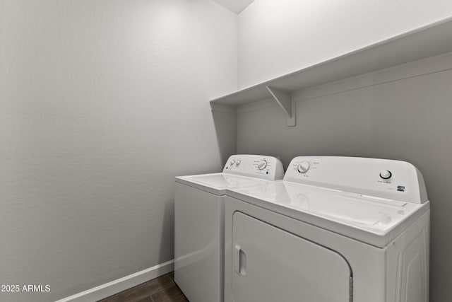 washroom featuring dark hardwood / wood-style flooring and washer and clothes dryer