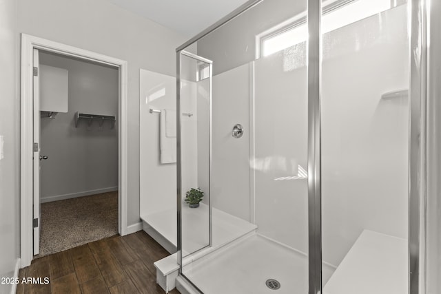 bathroom featuring wood-type flooring and a shower with door