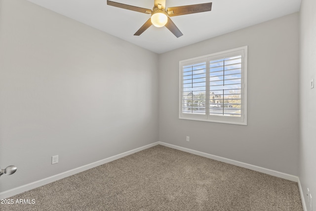 carpeted empty room featuring ceiling fan