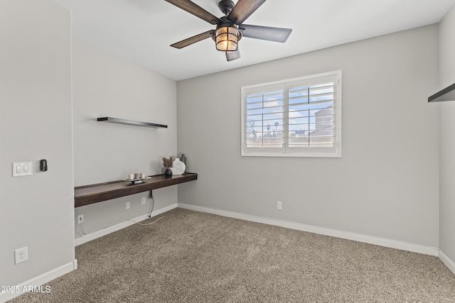 carpeted empty room featuring ceiling fan