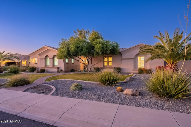 mediterranean / spanish house featuring a lawn