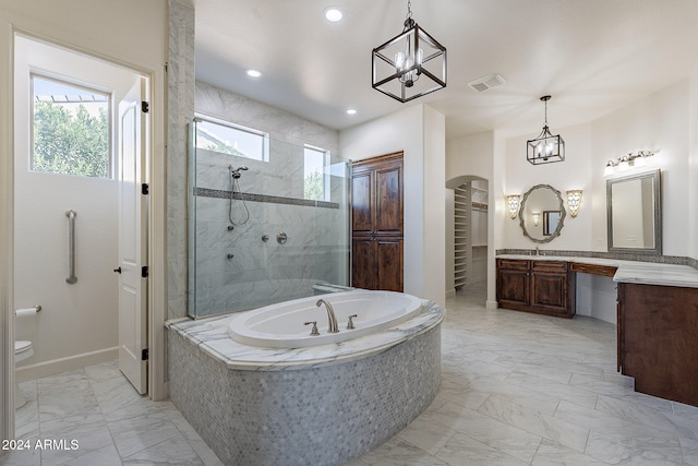 bathroom featuring vanity and independent shower and bath