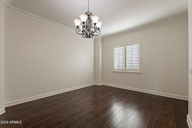 empty room featuring a notable chandelier, dark hardwood / wood-style floors, and crown molding