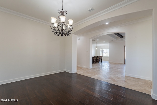 empty room with wood-type flooring, a notable chandelier, and ornamental molding