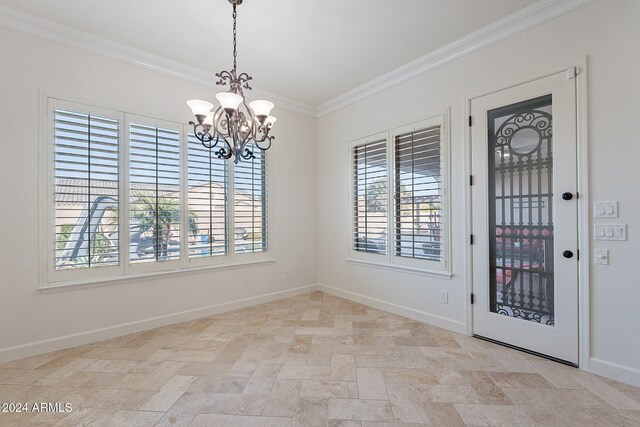 unfurnished dining area with ornamental molding, plenty of natural light, and an inviting chandelier