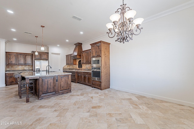 kitchen with stainless steel appliances, an island with sink, decorative light fixtures, and tasteful backsplash