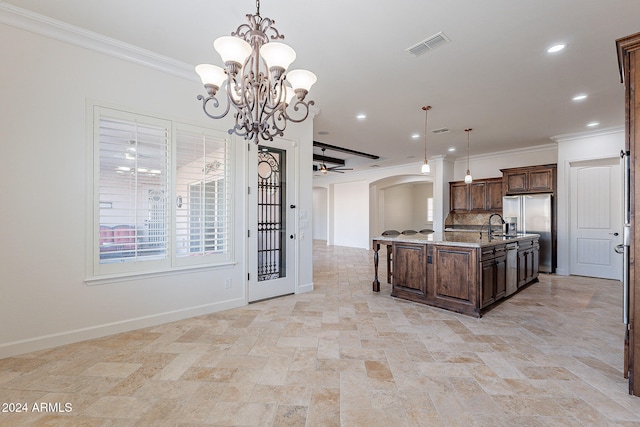 kitchen featuring crown molding, pendant lighting, stainless steel refrigerator with ice dispenser, light stone countertops, and a kitchen island with sink