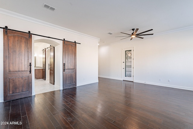 empty room featuring dark wood-type flooring, ceiling fan, and crown molding