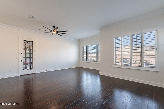 spare room featuring dark wood-type flooring, ceiling fan, and crown molding