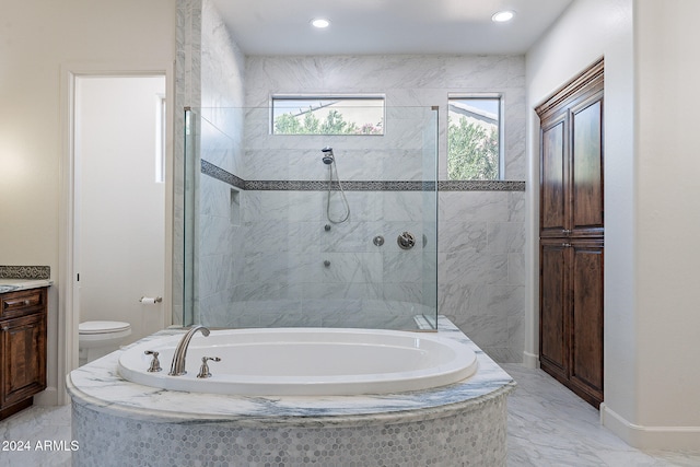 full bathroom featuring toilet, independent shower and bath, and vanity