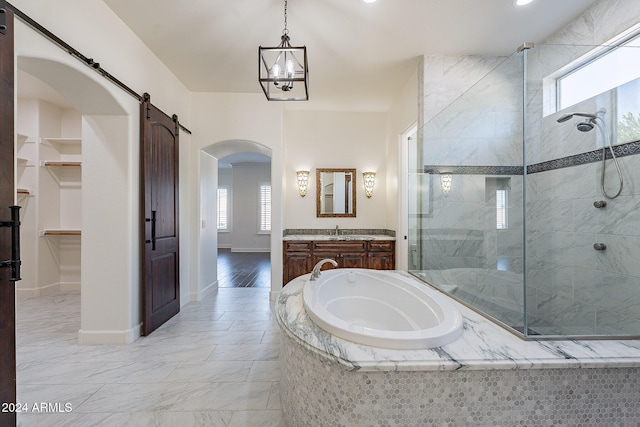 bathroom with a chandelier, independent shower and bath, and vanity