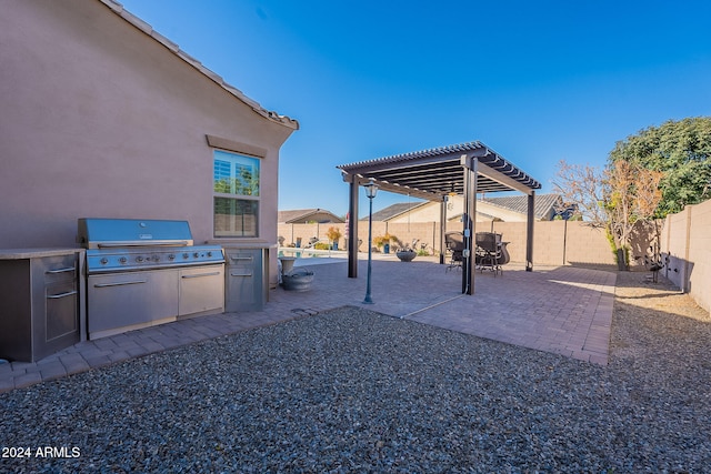 view of patio / terrace with an outdoor kitchen and a pergola