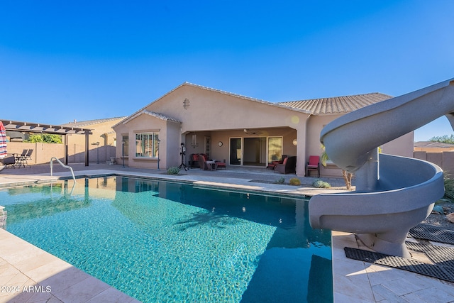 view of pool featuring a patio area, ceiling fan, and a water slide