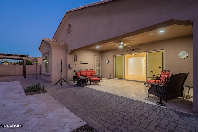 back of property with a patio, an outdoor living space, and ceiling fan