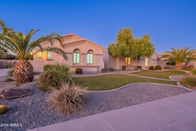 mediterranean / spanish-style house featuring a yard