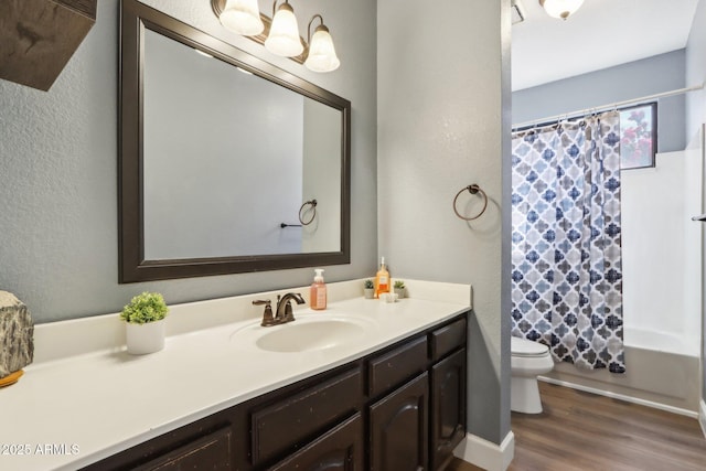 full bathroom featuring vanity, hardwood / wood-style flooring, shower / bath combination with curtain, and toilet