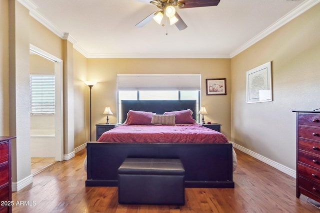 bedroom with crown molding, hardwood / wood-style floors, and ceiling fan