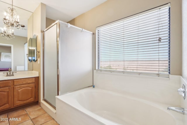 bathroom featuring a chandelier, tile patterned floors, vanity, and separate shower and tub