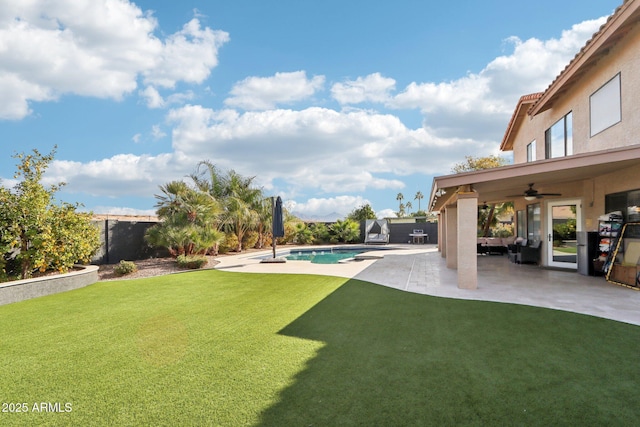 view of yard featuring ceiling fan and a patio area