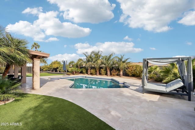 view of swimming pool featuring a yard and a patio area