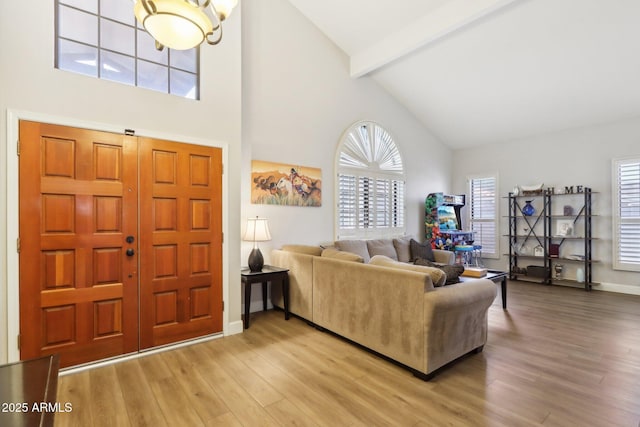 living room with high vaulted ceiling, beam ceiling, and hardwood / wood-style floors