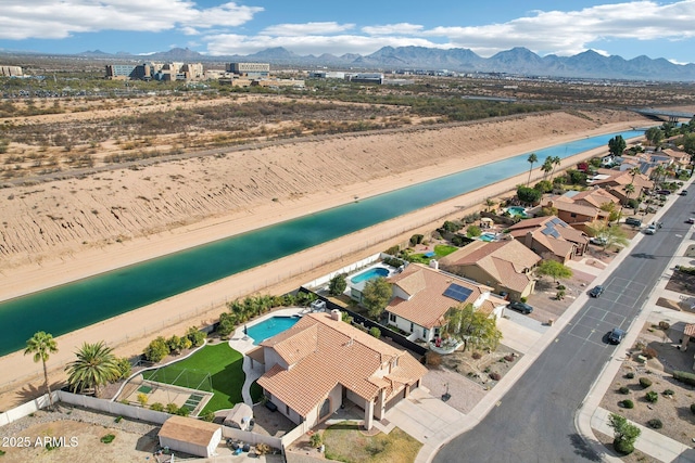 drone / aerial view with a water and mountain view